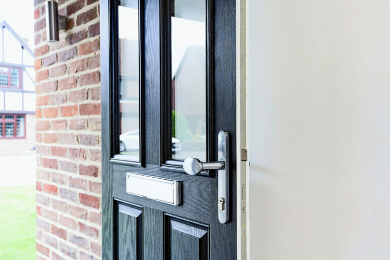 Three counties installation of composite front door, by door-stop.