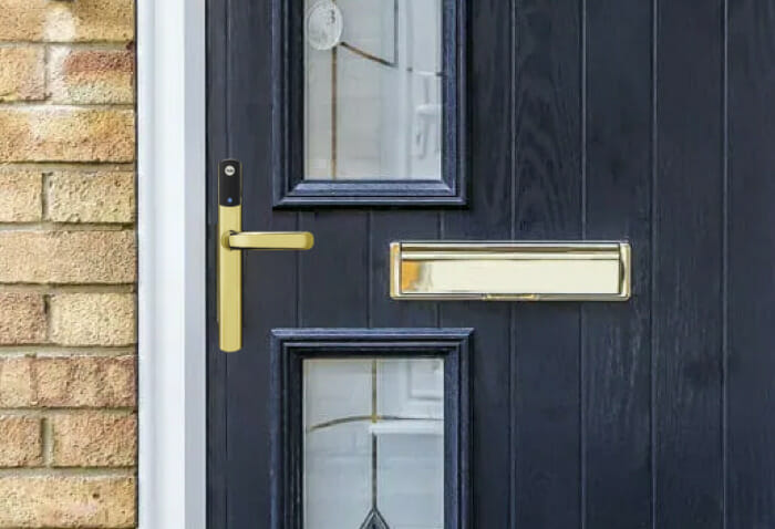 Gold smart door lock on blue composite door.