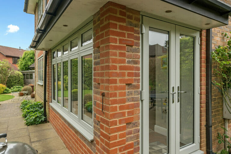 A close up photograph of a wide window and patios doors of the property in this Spotlight Installation by Three Counties