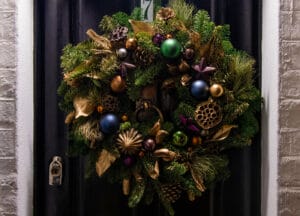 A front door with a christmas decoration hanging on it. Home decor ideas