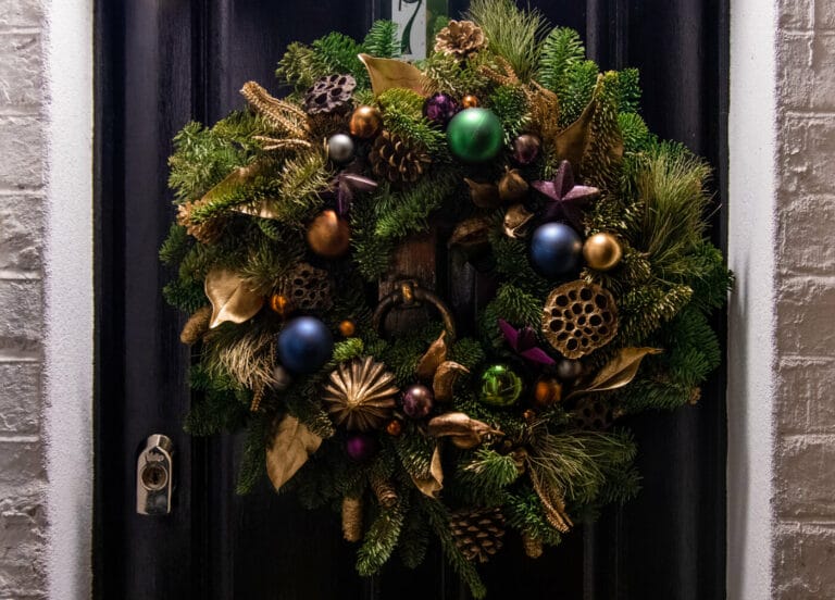 A front door with a christmas decoration hanging on it. Home decor ideas